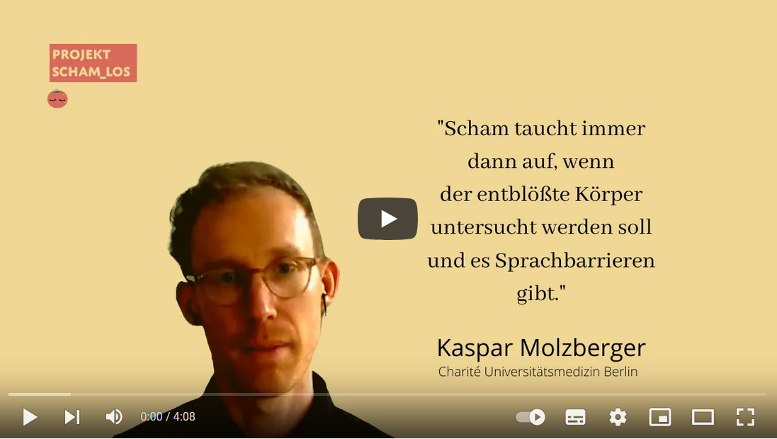 Eine Wissenschaftlerin und ein Wissenschaftler arbeiten hinter einer Glasfassade und mischen Chemikalien mit Großgeräten.